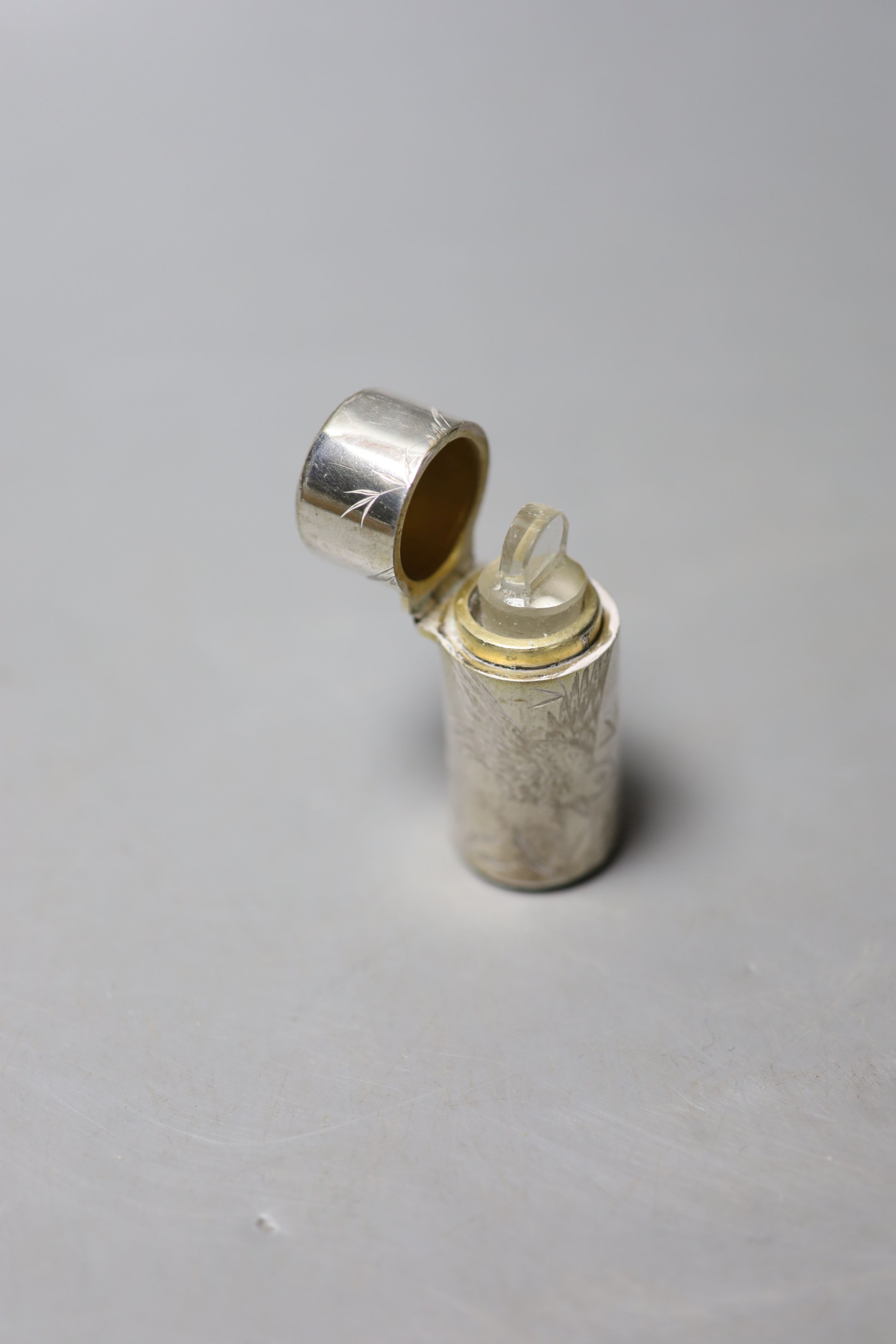 A Victorian silver cylindrical scent bottle, with aesthetic engraved decoration, Hall & Goode, London, 1886, 59mm.